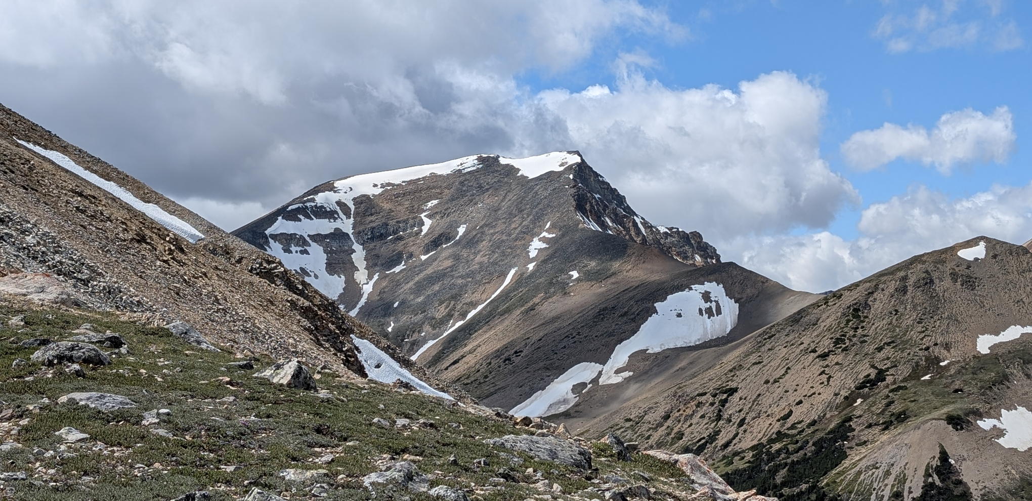 Photograph of a distant summit from an alpine ridgeline