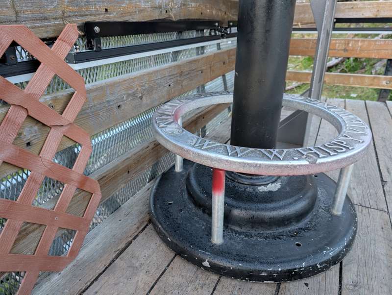 Stains from a red smoke bomb on a metal binocular stand