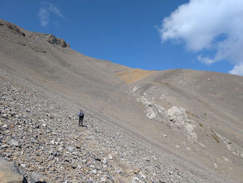 Eric walks along a well-defined trail towards the summit.