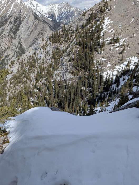 A snow ramp leading to a long fall on Grotto Mountain
